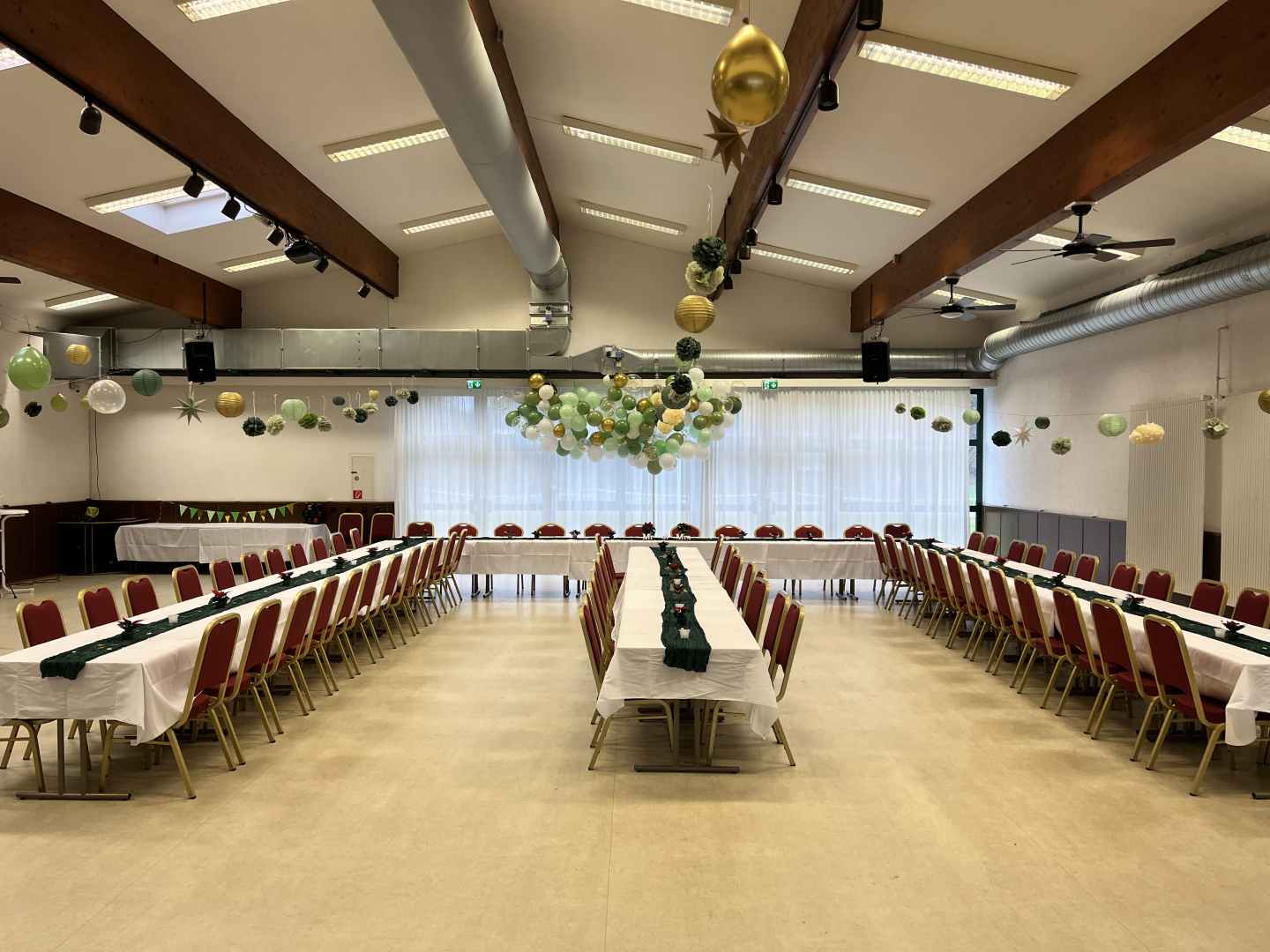 Das Bild zeigt ein aufgebautes Tischset in U-Form mit Hochzeitsdeko